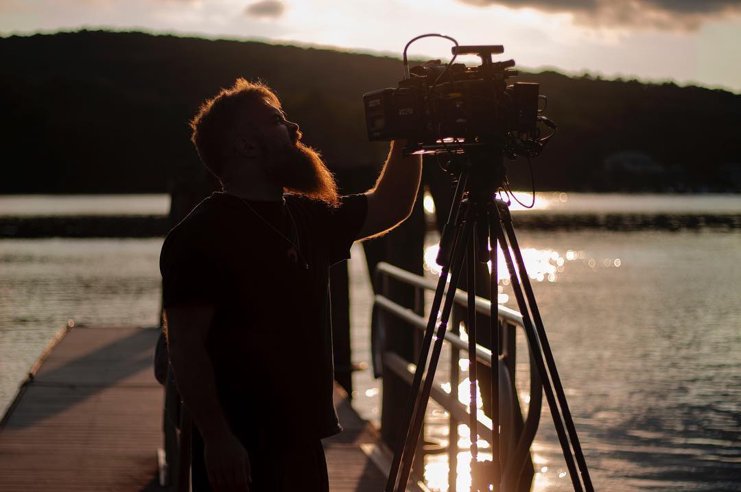 Filming on a dock at sunset