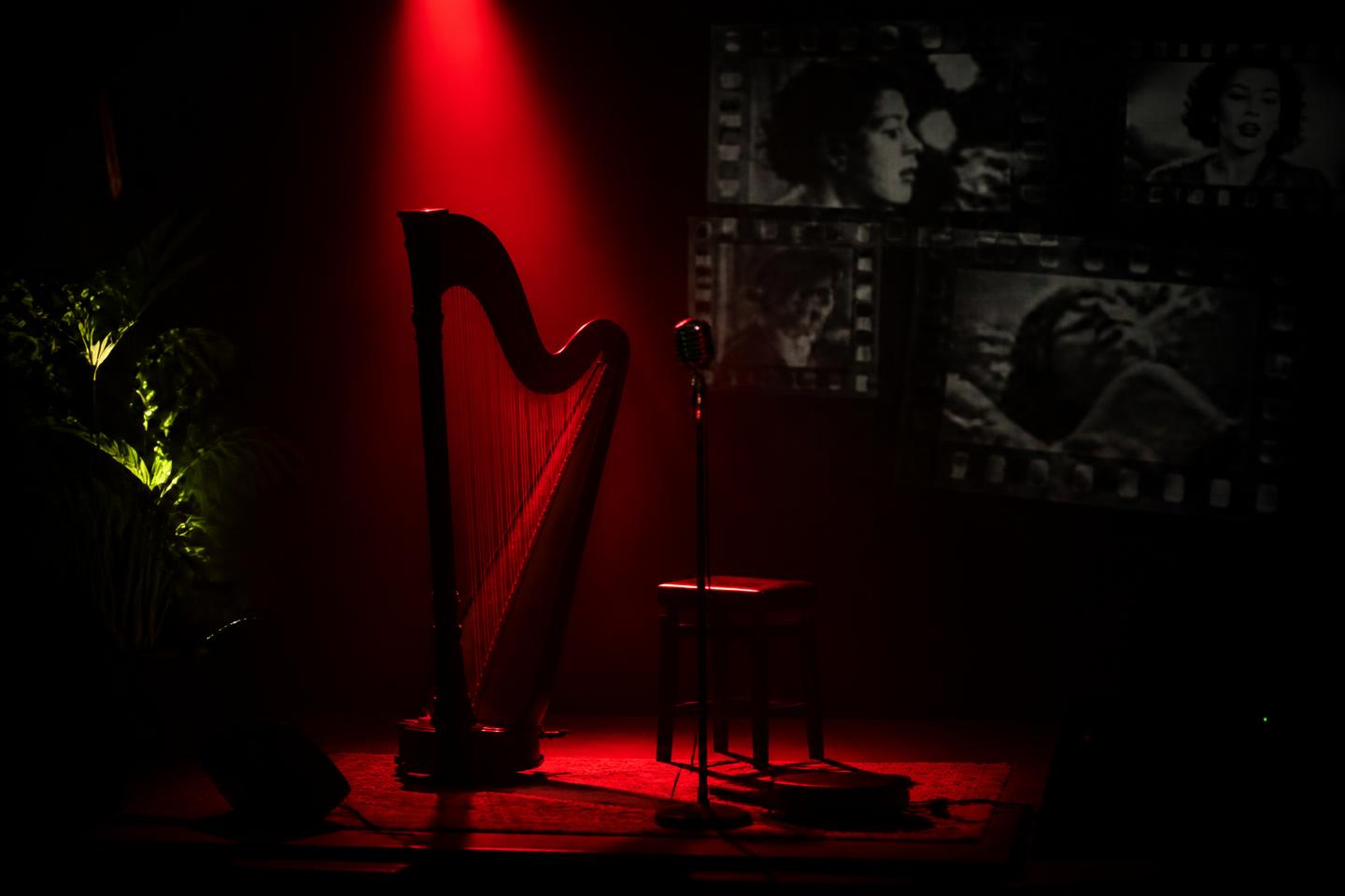 Stage set for the Life Story Poem Show with harp and spotlight