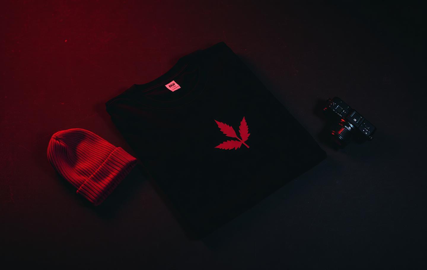 Tweaked Productions merchandise flat-lay with black and red apparel